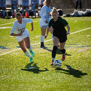 Female soccer player chasing the ball